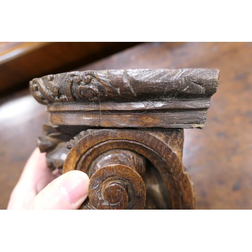 507 - Late 17th Century carved oak bracket, carved with a grotesque mask and paper scroll, 22cm x 16.5cm