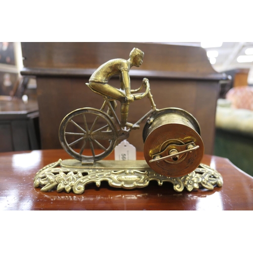 560 - British United Clock Company racing bicycle clock, circa 1910, the clock with Arabic numerals, signe... 