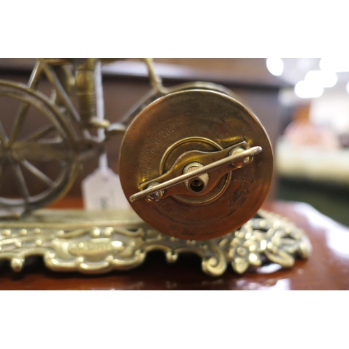 560 - British United Clock Company racing bicycle clock, circa 1910, the clock with Arabic numerals, signe... 