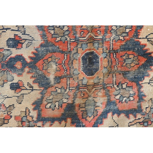 670 - Persian Malayer woollen rug, late 19th Century, centred with a red flowerhead motif within a fawn re... 