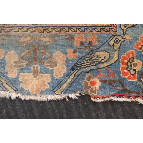 670 - Persian Malayer woollen rug, late 19th Century, centred with a red flowerhead motif within a fawn re... 