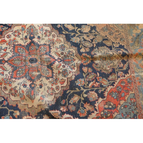 670 - Persian Malayer woollen rug, late 19th Century, centred with a red flowerhead motif within a fawn re... 