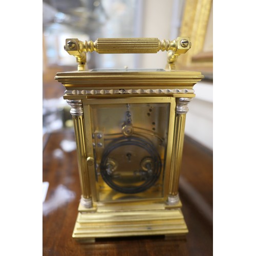 535 - Brass repeating carriage clock, having a printed dial with Roman numerals, within brass fretted surr... 