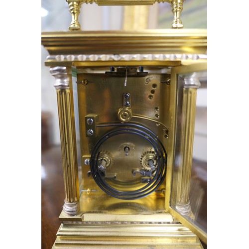 535 - Brass repeating carriage clock, having a printed dial with Roman numerals, within brass fretted surr... 