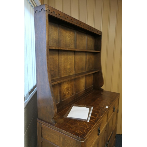 698 - Workshop of Robert 'Mouseman' Thompson, English oak dresser and plate rack, post 1971, the panelled ... 