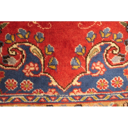 630 - Tabriz red ground woollen carpet, centred with a blue, red and fawn pendant medallion bordered with ... 