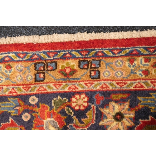 630 - Tabriz red ground woollen carpet, centred with a blue, red and fawn pendant medallion bordered with ... 