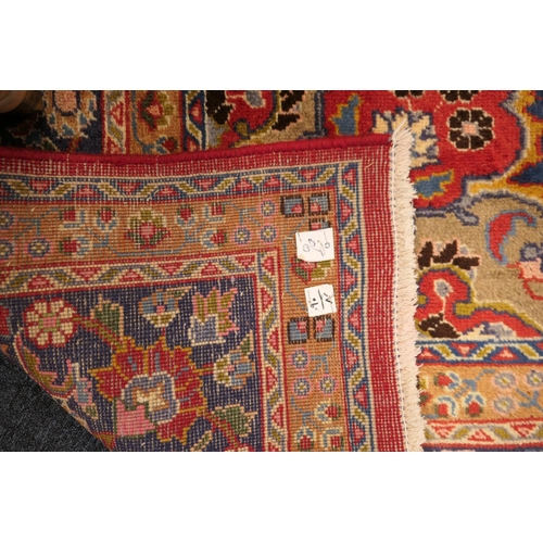 630 - Tabriz red ground woollen carpet, centred with a blue, red and fawn pendant medallion bordered with ... 