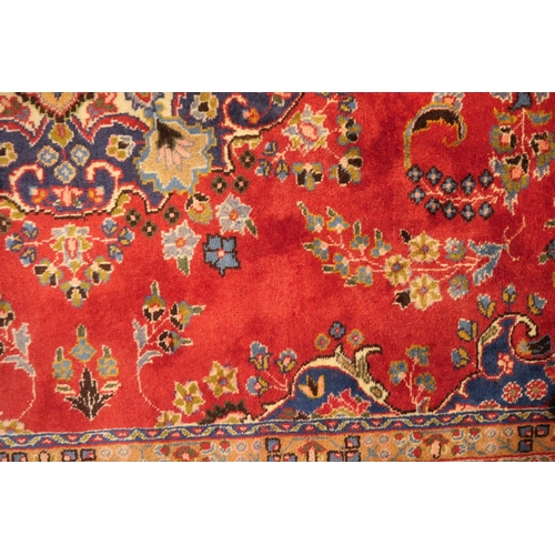 630 - Tabriz red ground woollen carpet, centred with a blue, red and fawn pendant medallion bordered with ... 