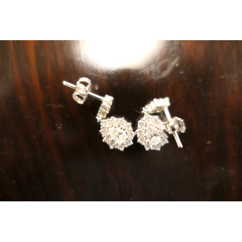 406 - Pair of diamond cluster pendant earrings, each centred with a pear cut diamond of approx. 0.5ct, est... 