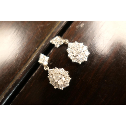 406 - Pair of diamond cluster pendant earrings, each centred with a pear cut diamond of approx. 0.5ct, est... 