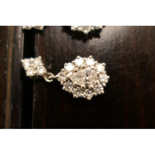 406 - Pair of diamond cluster pendant earrings, each centred with a pear cut diamond of approx. 0.5ct, est... 