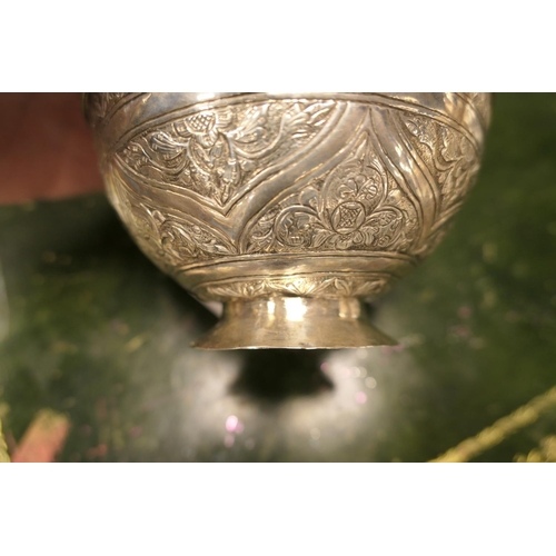 154 - Indian white metal covered bowl, chased with floral trails, over a small circular foot, 10.5cm diame... 