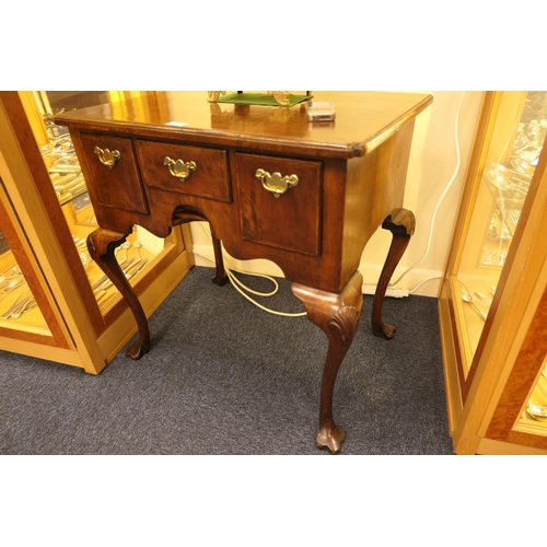 713 - Queen Anne style walnut lowboy, feather banded top with kick-in corners, over three drawers with cen... 