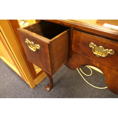 713 - Queen Anne style walnut lowboy, feather banded top with kick-in corners, over three drawers with cen... 