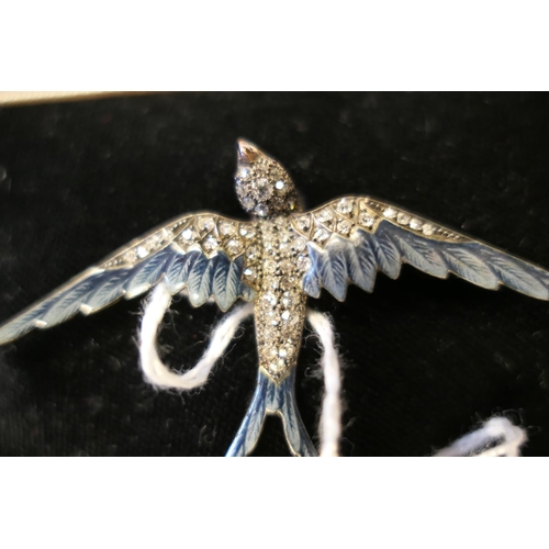 436 - Diamond and enamel swallow brooch, set with 53 small round cut diamonds and cabochon ruby eyes, the ... 