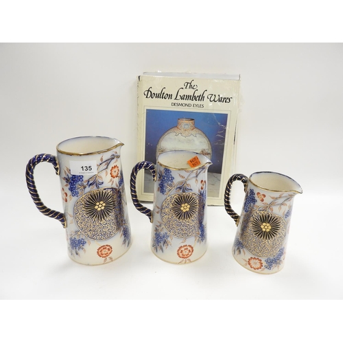 135 - Set of three Doulton Burslem aesthetic period jugs; also a copy of Eyles 'The Doulton Lambeth Wares'