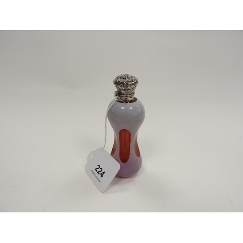 224 - Victorian ruby glass and lilac overlay waisted scent bottle, with chased white metal cap and origina... 