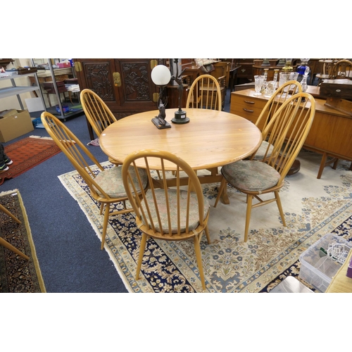 655 - Ercol drop leaf circular dining table, width 128cm, when extended 140cm, together with six hoop back... 