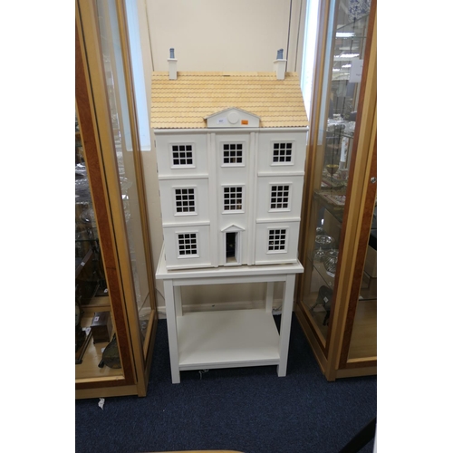 657 - Modern doll's house on a table stand, total height 155cm