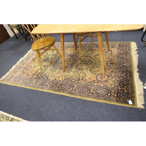 659 - Persian style fawn green ground woollen rug, 223cm x 144cm