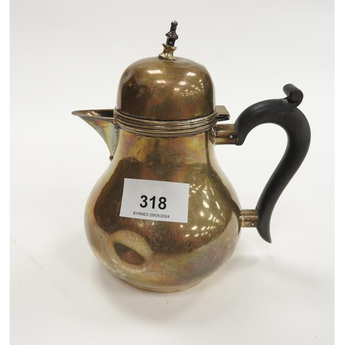 318 - George V silver pear shaped hot water jug, Chester 1920, with later brass finial and ebony handle, h... 