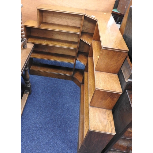 594 - 1930s oak corner open bookcase, one side being 120cm in length, the other 103cm, height 107cm, depth... 