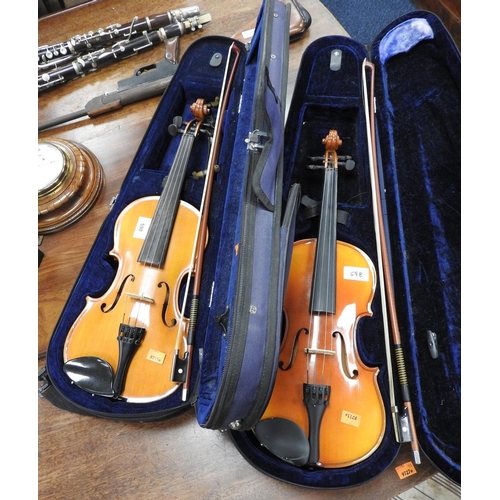 598 - Two cased students' violins, each with 13.25