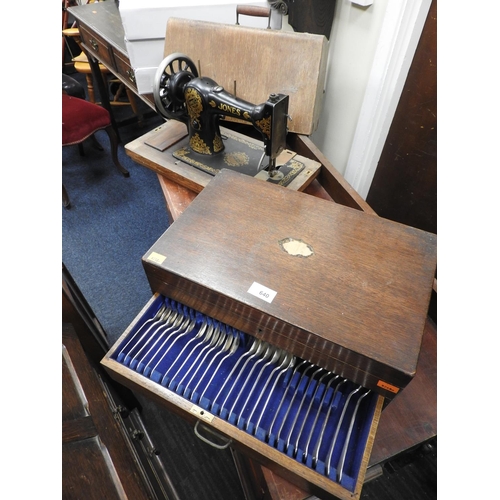 640 - Vintage Jones sewing machine; also an oak part canteen of silver plated cutlery