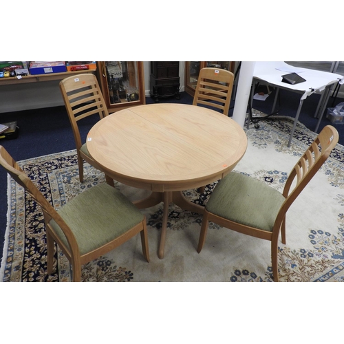 666 - Modern light oak finish extendable circular dining table, when closed 104cm diameter, together with ... 