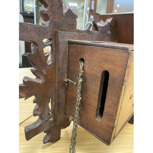 497 - Swiss cuckoo clock with pendulum and two pine cone cast iron weights, width 30.5cm, height without p... 