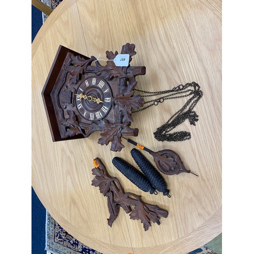 497 - Swiss cuckoo clock with pendulum and two pine cone cast iron weights, width 30.5cm, height without p... 