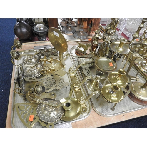 64 - Assortment of ornamental brass wares including wall sconces, trivets etc (2 trays)