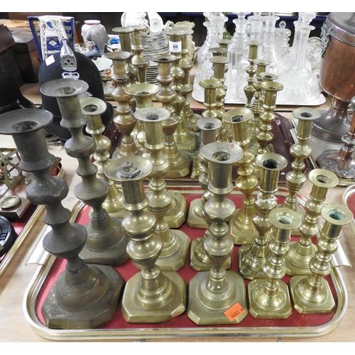 69 - Number of Victorian brass candlesticks, mostly in pairs (2 trays)