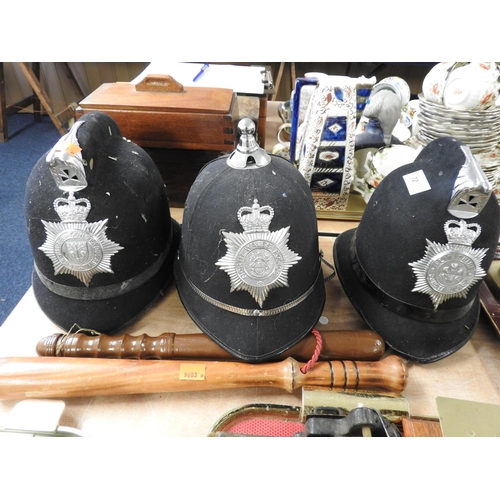 72 - North Wales police helmet, also Cheshire and Flintshire Constabulary helmets and two wooden truncheo... 