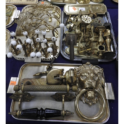 113 - Assorted brass door furniture, also eight Victorian gilt brass and ceramics coat hooks, lion's mask ... 