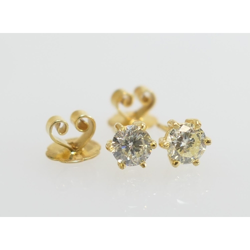 106 - Pair of diamond ear studs, the brilliant cut diamonds totalling approx. 1.26cts, O/Q in colour, I2 c... 