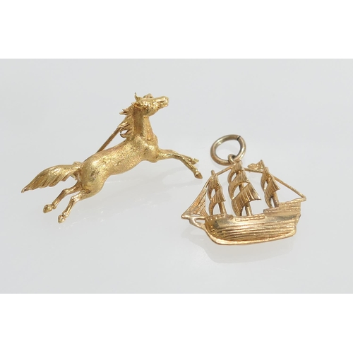 115 - 18ct gold galloping horse brooch, 37mm,  weight approx. 6.4g; also a 9ct gold galleon charm, 25mm, w... 