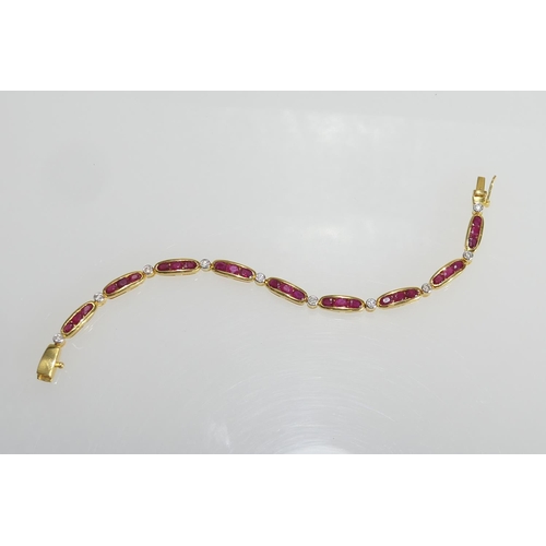 14 - Ruby and diamond line bracelet, set with nine bar links channel set with three oval cut rubies dispe... 