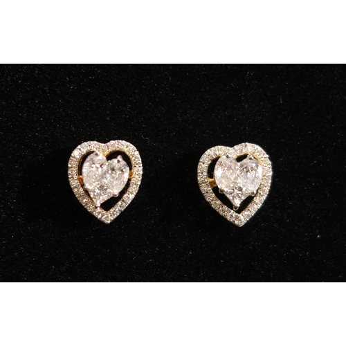 19 - Pair of  heart shaped diamond cluster ear studs, centred with two pear cut and one princess cut diam... 