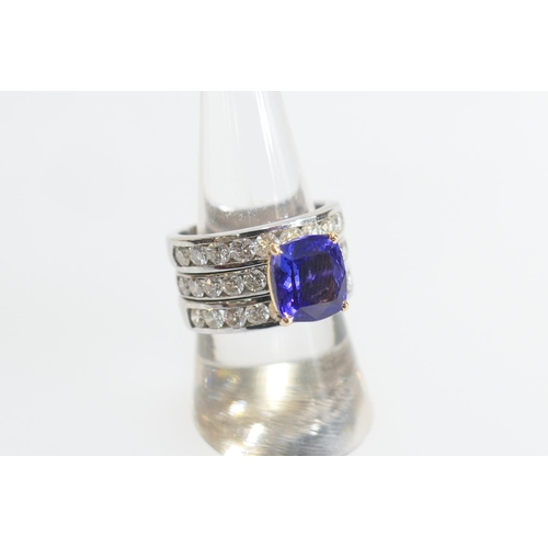 22 - Tanzanite and diamond trinity ring, centred with a removable ring set with a cushion cut tanzanite o... 