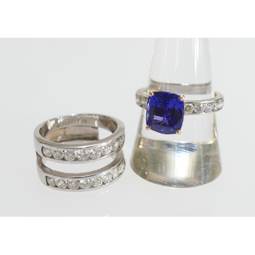 22 - Tanzanite and diamond trinity ring, centred with a removable ring set with a cushion cut tanzanite o... 