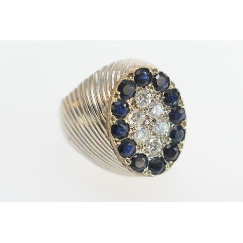 25 - Sapphire and diamond pave set ring, centred with six small brilliant cut diamonds and bordered with ... 