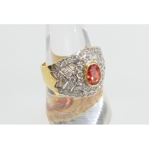 28 - Fire opal and diamond cluster ring, the central oval cut reddish-orange gemstone of approx. 7mm x 4.... 