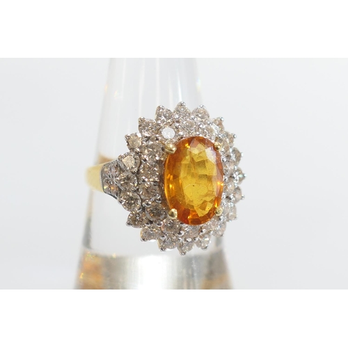 32 - Orange gemstone and diamond cluster ring, the central orange stone approx. 11mm x 8mm, in a four cla... 