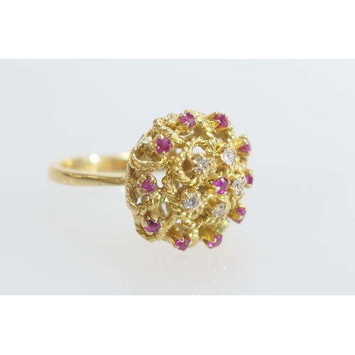 35 - Eastern ruby and diamond cluster ring in 18ct gold, the tiny stones set in an open knotted rope sett... 