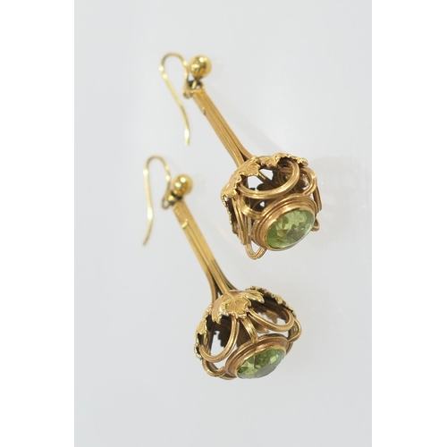 36 - Pair of Edwardian 9ct gold and peridot pendant earrings, worked with vine leaves set to the undersid... 