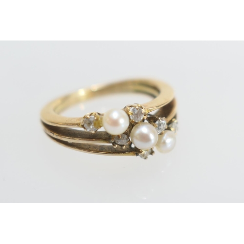 38 - Diamond and pearl trinity ring, set with three small pearls of approx. 3mm diameter flanked by six c... 