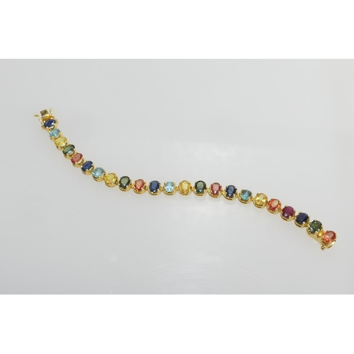 40 - Attractive multi-coloured sapphire bracelet, set with 23 multi-coloured oval cut stones, totalling a... 