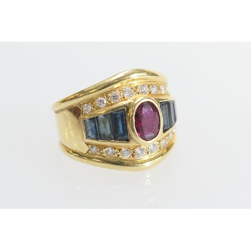 42 - Ruby, sapphire and diamond dress ring, the central oval ruby of approx. 6mm x 5mm, collet set and bo... 